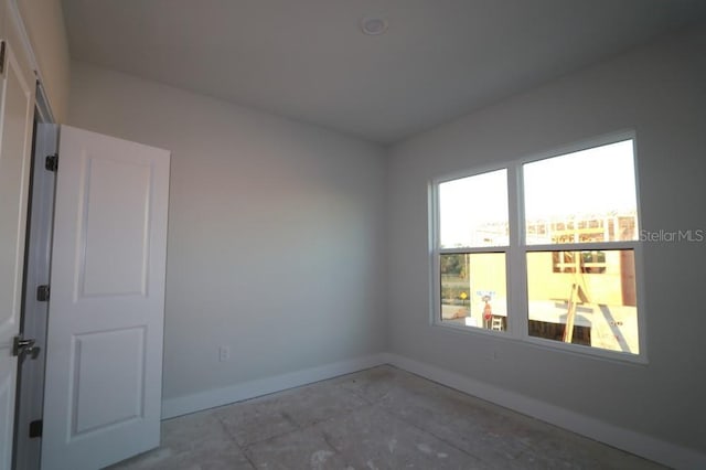 unfurnished room featuring baseboards