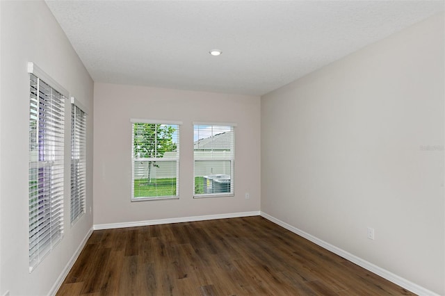 unfurnished room featuring dark hardwood / wood-style floors