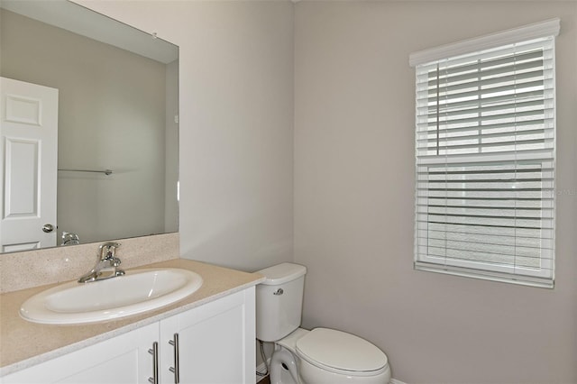 bathroom featuring toilet and vanity