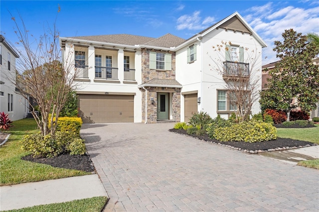 view of front of house with a garage and a balcony