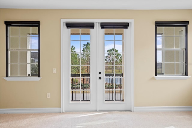 doorway to outside with french doors and carpet flooring