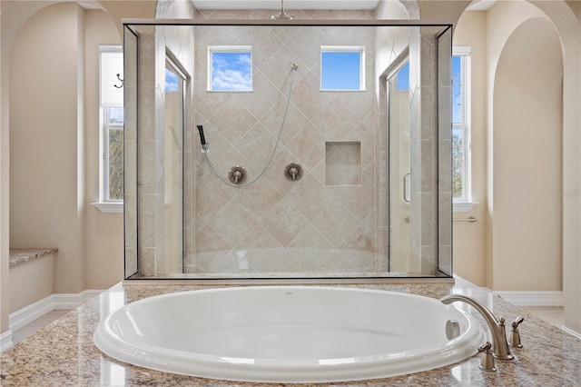 bathroom featuring separate shower and tub