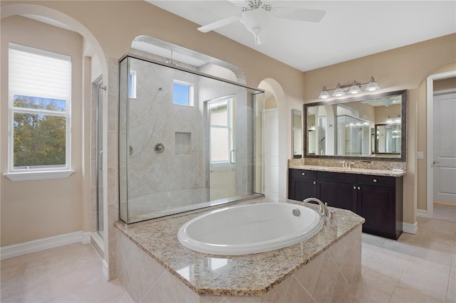 bathroom featuring vanity, tile patterned flooring, independent shower and bath, and a healthy amount of sunlight