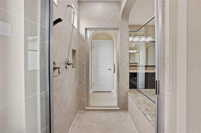 bathroom featuring vanity and a tile shower