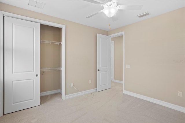 unfurnished bedroom with light carpet, a closet, and ceiling fan