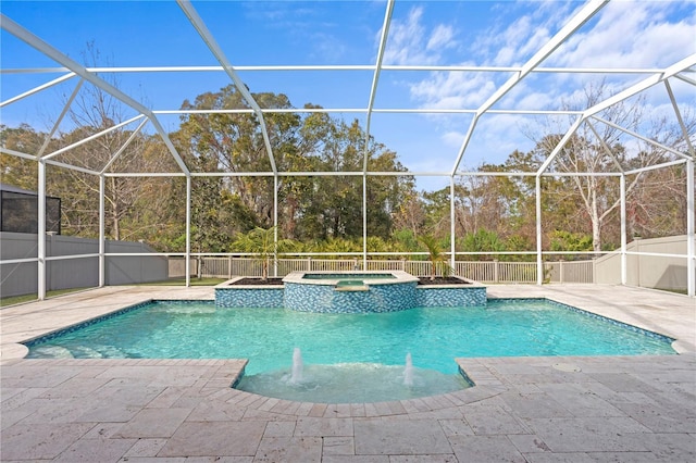 view of pool with an in ground hot tub, pool water feature, a patio area, and glass enclosure