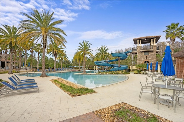 view of pool featuring a patio area and a water slide