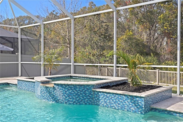 view of swimming pool featuring a lanai and an in ground hot tub