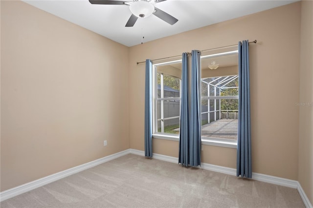 spare room featuring ceiling fan and light colored carpet