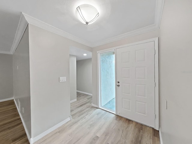 foyer entrance featuring ornamental molding and light hardwood / wood-style flooring