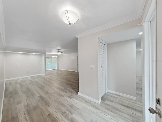 interior space featuring crown molding, light hardwood / wood-style flooring, and ceiling fan