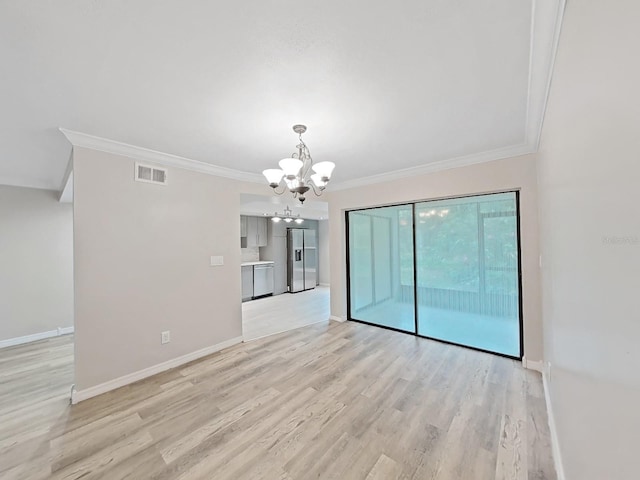 empty room featuring light hardwood / wood-style flooring, ornamental molding, and a chandelier