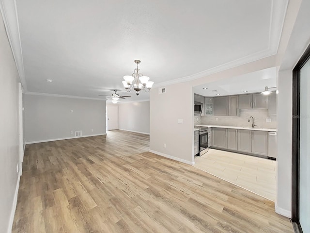 unfurnished living room featuring sink, crown molding, and light wood-type flooring