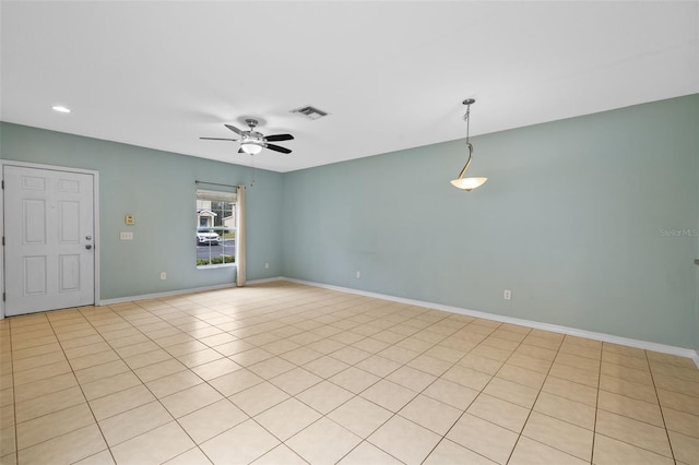 spare room featuring ceiling fan and light tile patterned flooring