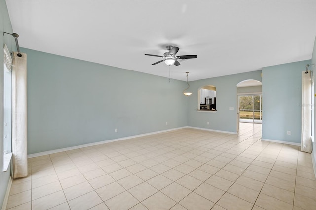 spare room featuring light tile patterned flooring and ceiling fan