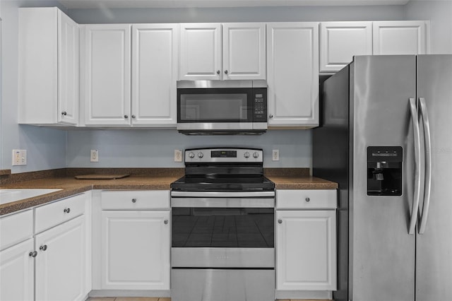 kitchen featuring stainless steel appliances and white cabinets