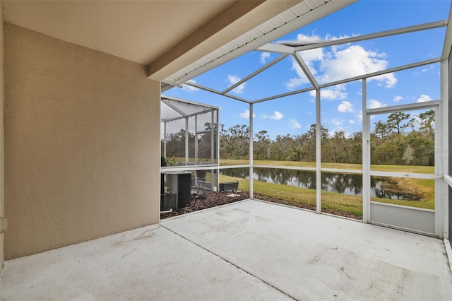 unfurnished sunroom featuring a water view