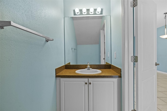 bathroom featuring tile patterned flooring and vanity