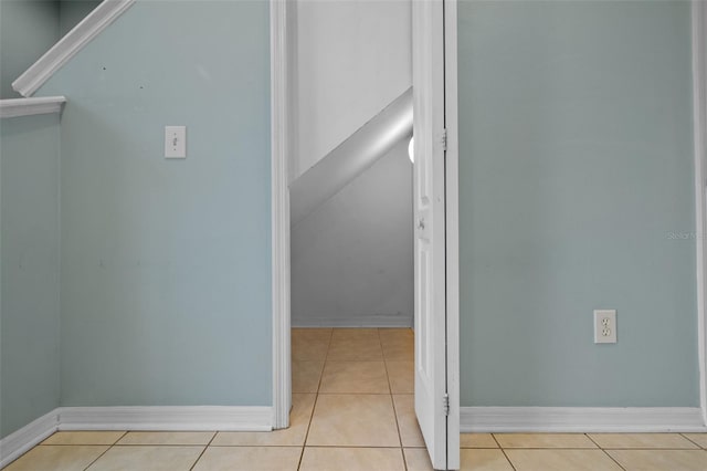 hall with light tile patterned floors