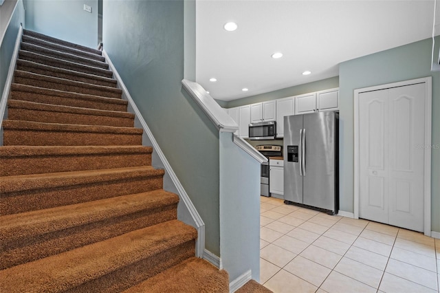 staircase with tile patterned floors