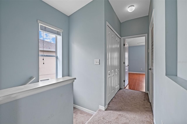 hall featuring light colored carpet