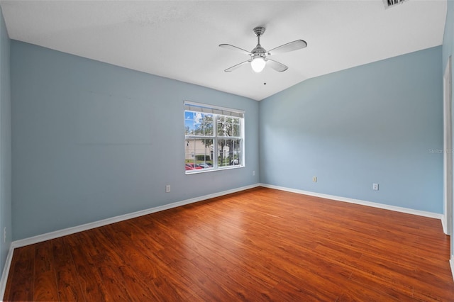 unfurnished room featuring lofted ceiling, hardwood / wood-style floors, and ceiling fan