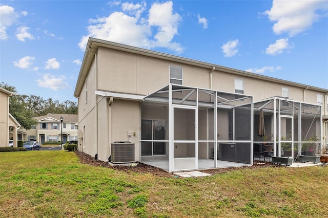 back of house featuring central AC, a yard, and a patio area