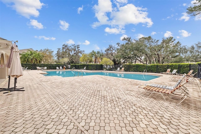 view of swimming pool featuring a patio area