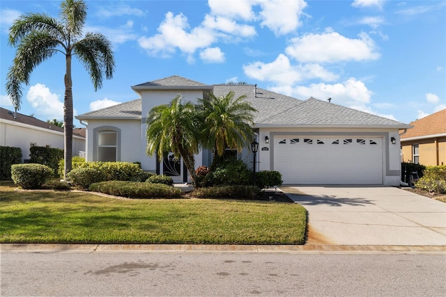 view of front of house with a garage and a front lawn