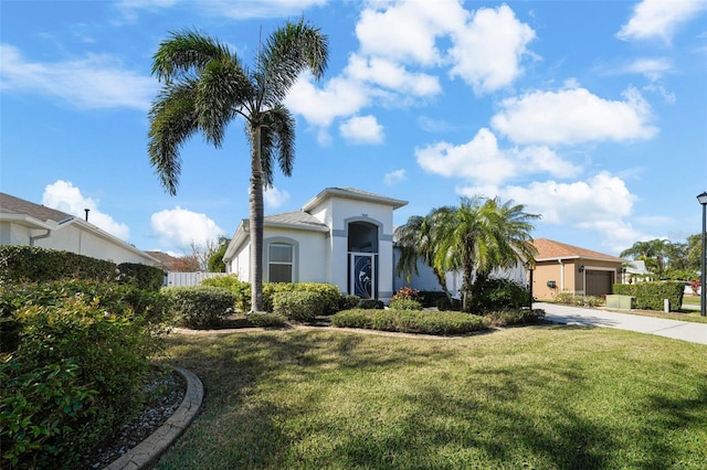 view of front of property with a garage and a front lawn