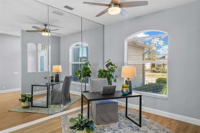 office area with hardwood / wood-style floors and ceiling fan