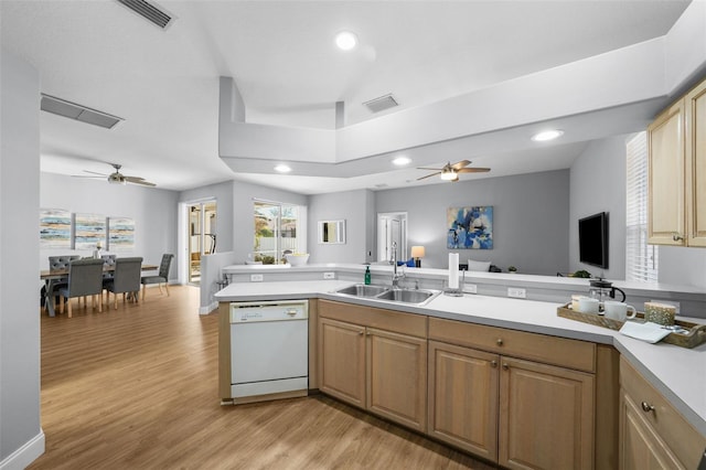 kitchen with sink, light wood-type flooring, white dishwasher, kitchen peninsula, and ceiling fan