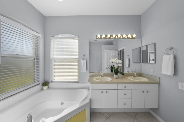 bathroom with tile patterned flooring, vanity, and a tub