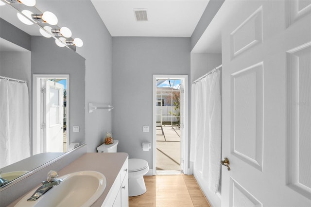 bathroom featuring hardwood / wood-style flooring, vanity, and toilet