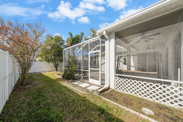 view of yard with a sunroom and glass enclosure