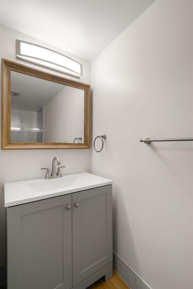 bathroom with vanity and hardwood / wood-style floors