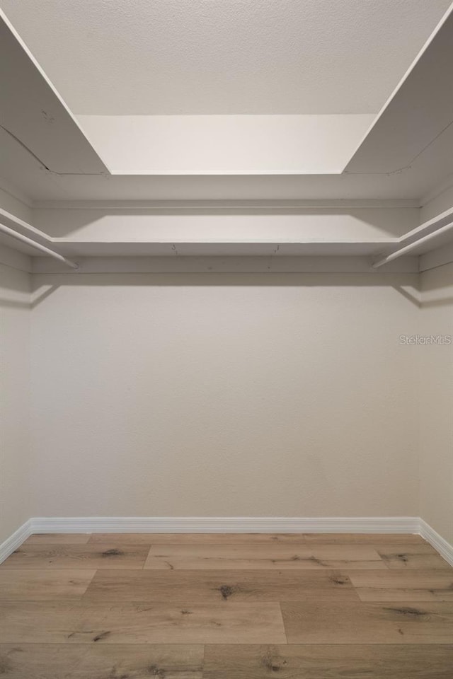 walk in closet featuring hardwood / wood-style floors