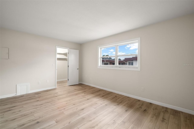 spare room featuring light hardwood / wood-style flooring