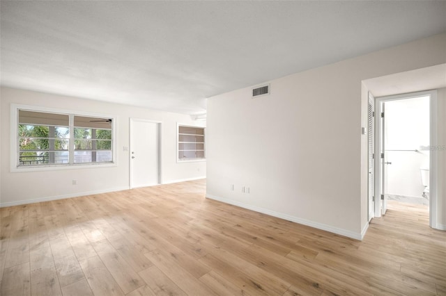 unfurnished room with light wood-type flooring