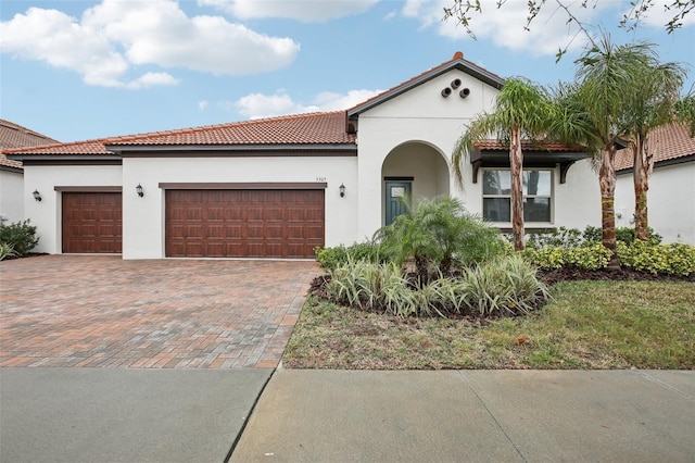 mediterranean / spanish home featuring a garage