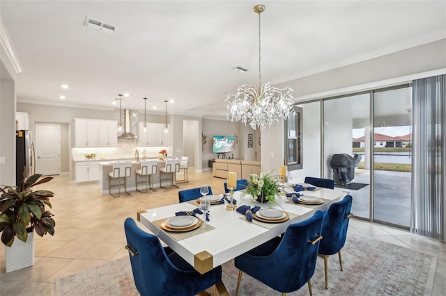 tiled dining space featuring an inviting chandelier and ornamental molding