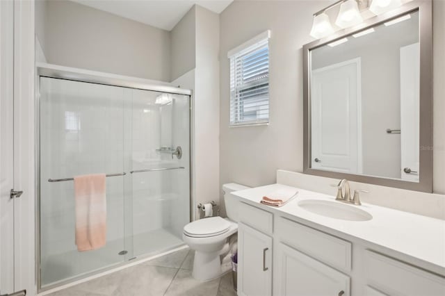 bathroom featuring vanity, toilet, an enclosed shower, and tile patterned flooring