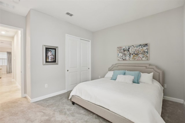 carpeted bedroom with a closet