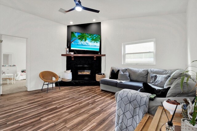 living room with hardwood / wood-style floors and ceiling fan