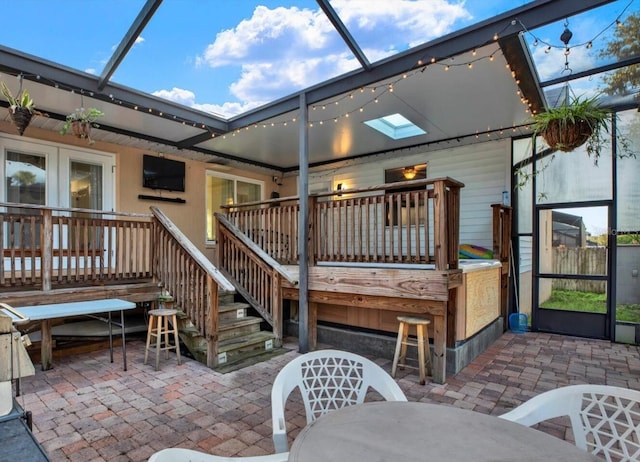 back of property with a lanai, a patio area, a deck, and exterior bar