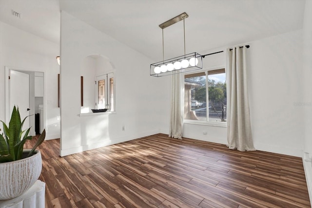 unfurnished dining area featuring dark hardwood / wood-style floors and high vaulted ceiling