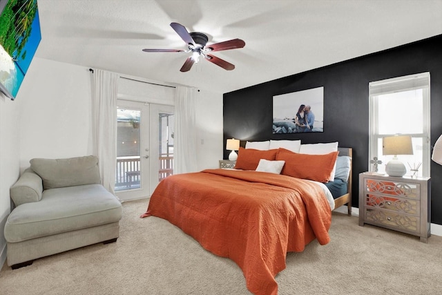 carpeted bedroom featuring access to outside, french doors, and ceiling fan