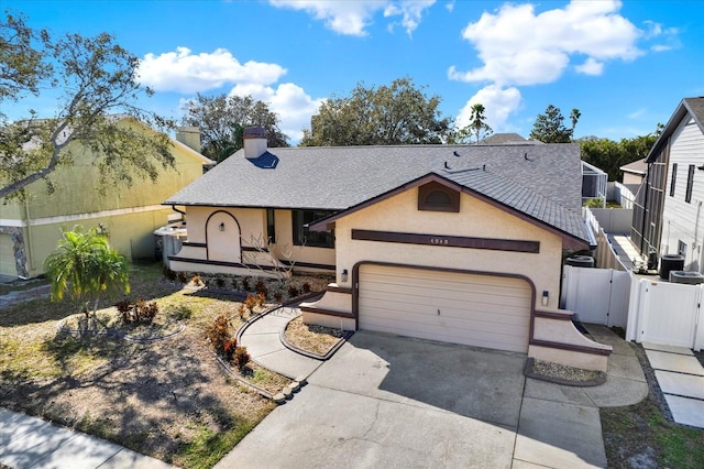 view of front of property with a garage and central air condition unit