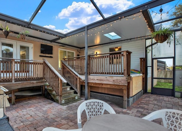 rear view of house with a patio area and glass enclosure