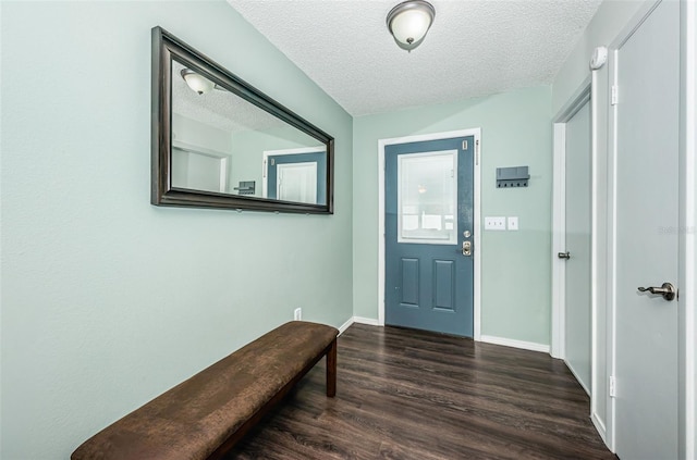 entrance foyer with dark hardwood / wood-style flooring and a textured ceiling